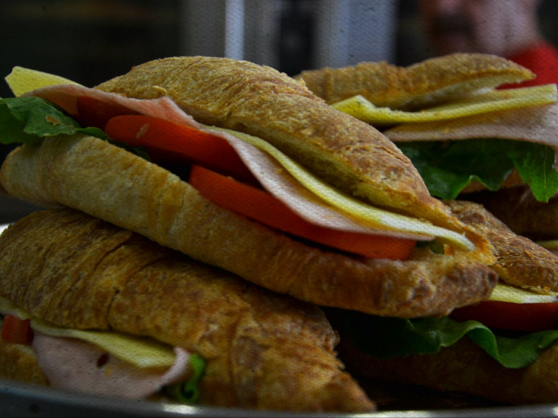 Croissant sandwiches with ham, cheese, and tomato